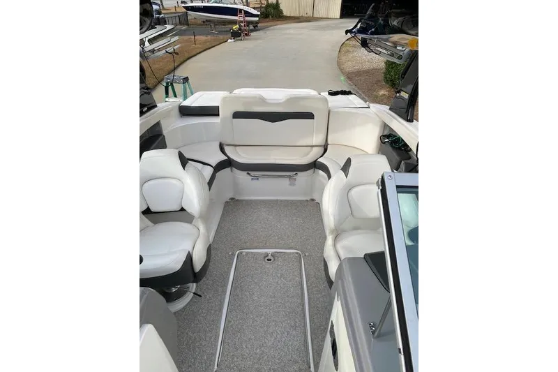 Slide: The Image of 2013 Chaparral 226 SSi boat interior with white seating and carpeted floor. - 8