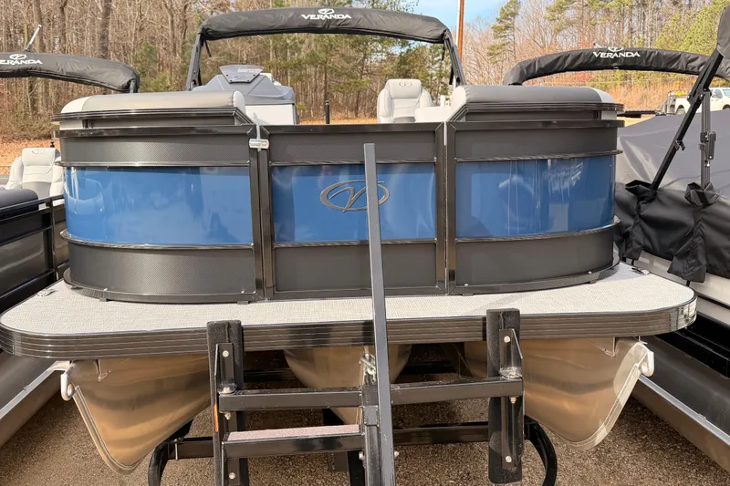 Slide: The Image of 2026 Veranda VR 235 RC pontoon boat with blue and black exterior, docked outdoors. - 1