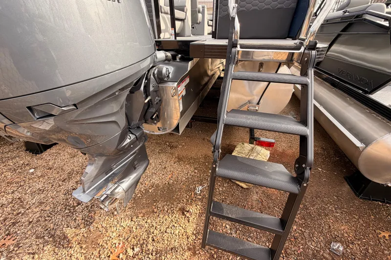 Slide: The Image of Veranda VR 235 RC 2026 boat with motor and boarding ladder on gravel. - 14