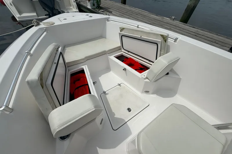 Slide: The Image of 2024 Aquasport 2200 Center Console boat interior with open storage compartments. - 11
