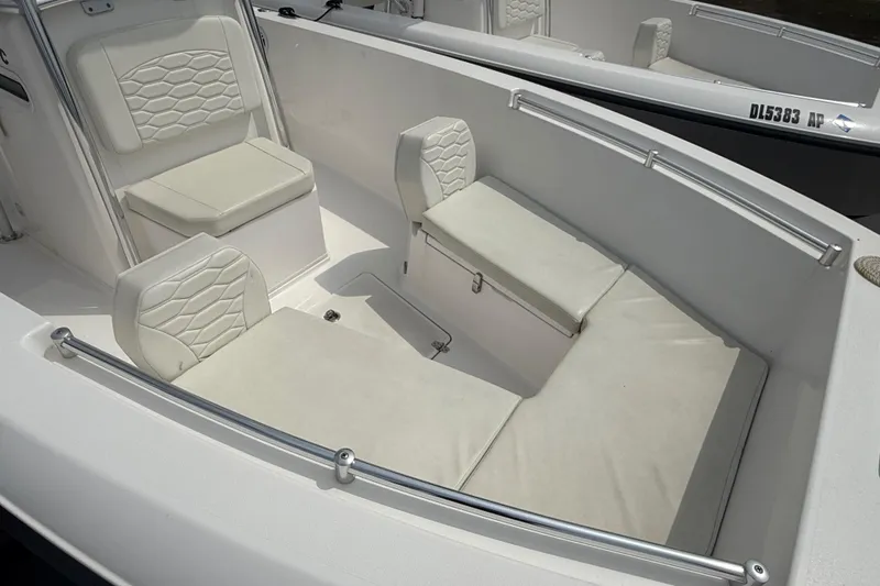 Slide: The Image of 2024 Aquasport 2200 Center Console boat interior with cushioned seating. - 4