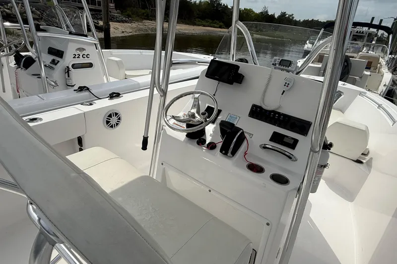 Slide: The Image of 2024 Aquasport 2200 Center Console boat interior with steering and control panel. - 5