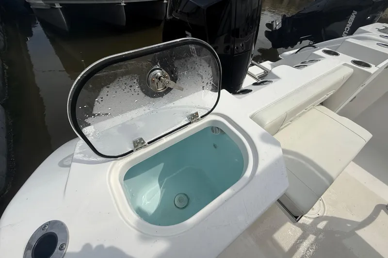 Slide: The Image of 2024 Aquasport 2200 Center Console boat with open livewell and seating area. - 8