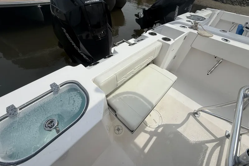 Slide: The Image of 2024 Aquasport 2200 Center Console boat interior with seating and livewell. - 9