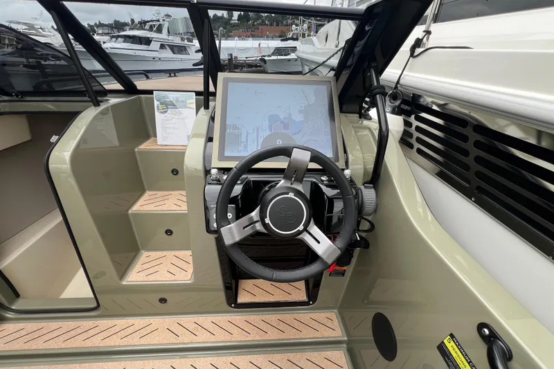 Slide: The Image of 2024 X Shore 1 boat cockpit with modern steering and navigation display. - 4
