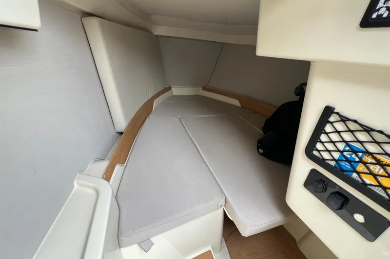 Slide: The Image of 2024 X Shore 1 cabin interior with cushioned seating and storage net. - 5