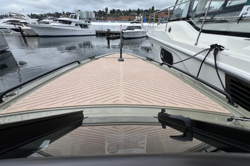 Slide: The Image of 2024 X Shore 1 boat docked, showcasing sleek design and modern deck. - 6