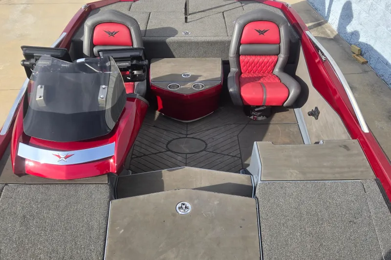 Slide: The Image of 2020 Vexus VX20 boat interior with red and gray seating, dual consoles, and carpeted flooring. - 12