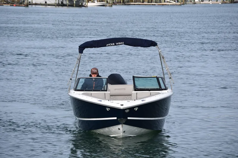 Slide: The Image of 2022 Four Winns H2 OB boat cruising on calm water. - 10