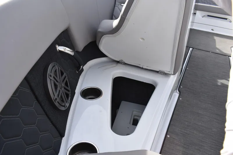 Slide: The Image of 2022 Four Winns H2 OB boat interior with storage compartment and cup holders. - 14