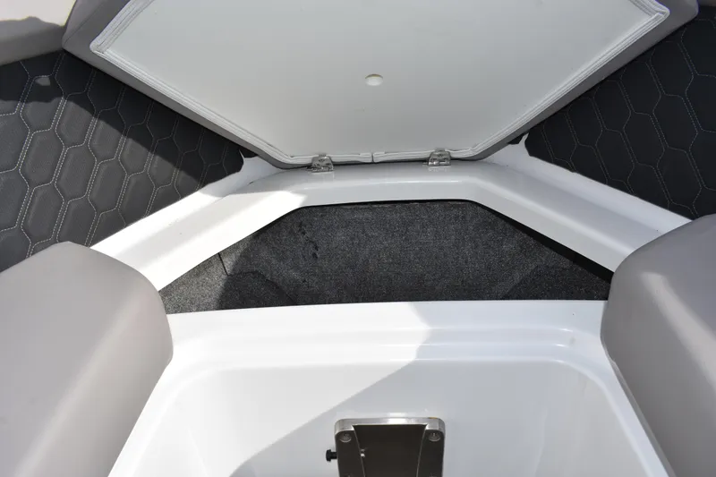 Slide: The Image of 2022 Four Winns H2 OB boat storage compartment with hexagonal pattern upholstery. - 15
