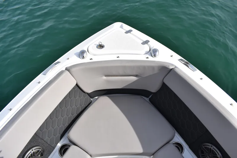 Slide: The Image of 2022 Four Winns H2 OB boat interior with cushioned seating and cup holders. - 16