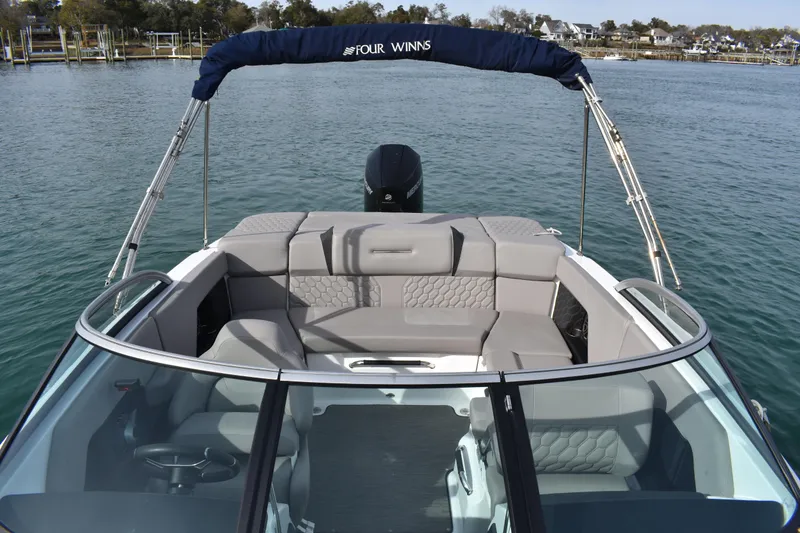 Slide: The Image of 2022 Four Winns H2 OB boat with sleek seating, on calm water. - 17