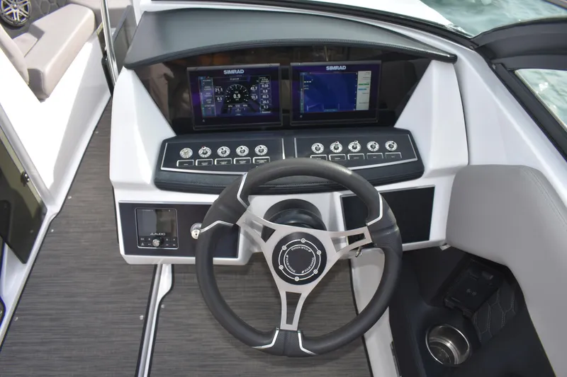 Slide: The Image of 2022 Four Winns H2 OB boat dashboard with steering wheel and digital displays. - 21