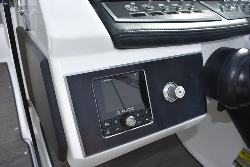Slide: The Image of 2022 Four Winns H2 OB boat dashboard with JL Audio system and controls. - 23