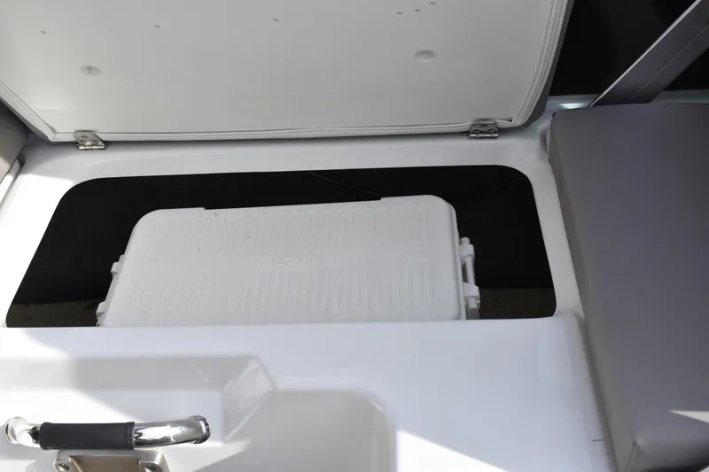 Slide: The Image of 2022 Four Winns H2 OB boat storage compartment with white cooler inside. - 30
