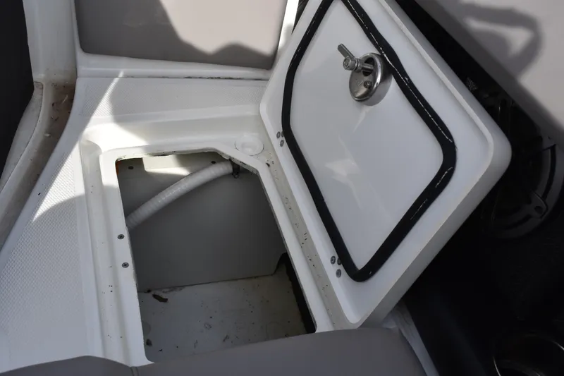 Slide: The Image of Open storage compartment on 2022 Four Winns H2 OB boat, showing interior space. - 31