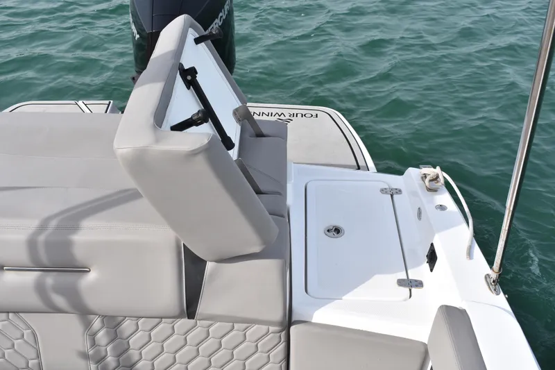 Slide: The Image of 2022 Four Winns H2 OB boat with gray seating and storage, on water. - 33