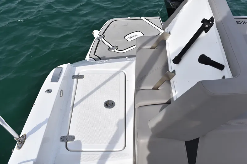 Slide: The Image of 2022 Four Winns H2 OB boat interior with seating and swim platform on water. - 35