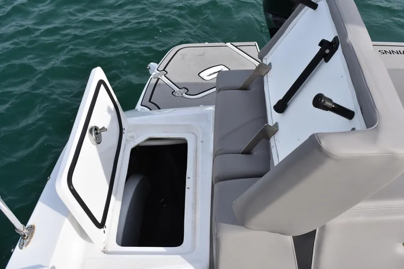 Slide: The Image of 2022 Four Winns H2 OB boat with open storage compartment and seating, on water. - 36