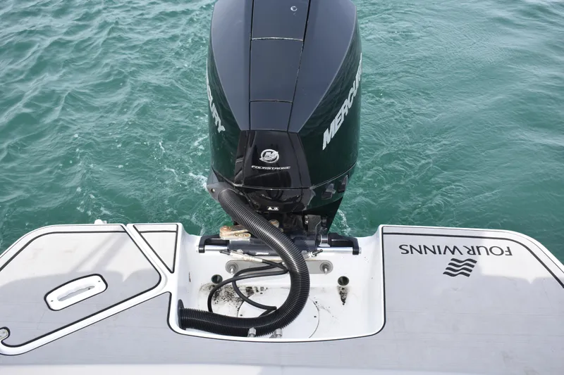 Slide: The Image of 2022 Four Winns H2 OB boat with Mercury outboard engine on water. - 39