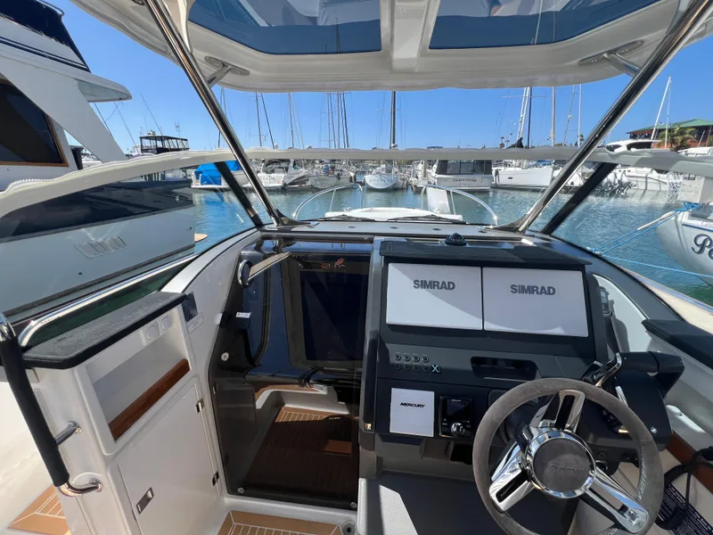 Slide: The Image of Nimbus T9 2024 boat cockpit with modern navigation system, docked at marina. - 14