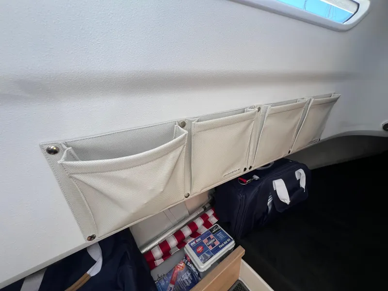 Slide: The Image of Interior storage pockets in a 2024 Nimbus T9 boat cabin. - 19