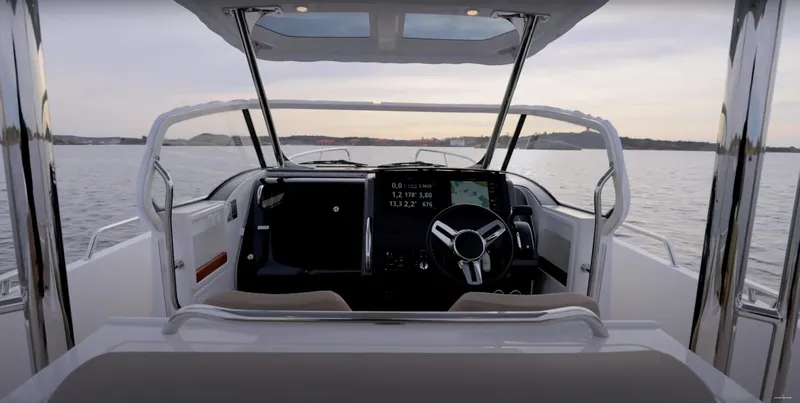 Slide: The Image of 2024 Nimbus T9 boat cockpit with modern steering and digital display on calm water. - 21