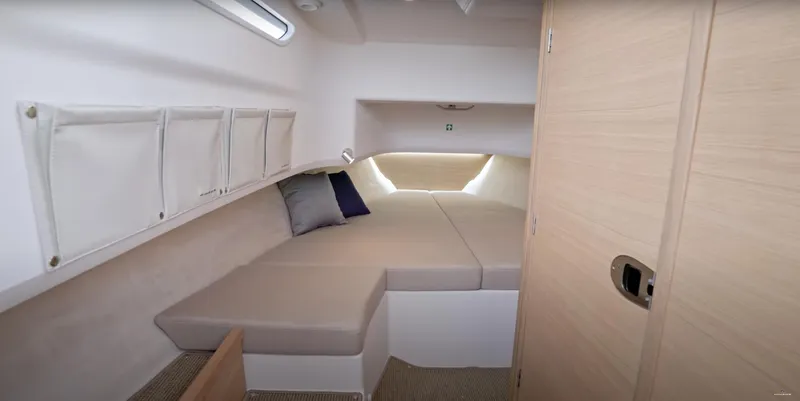 Slide: The Image of 2024 Nimbus T9 cabin interior with cozy bed and storage compartments. - 23