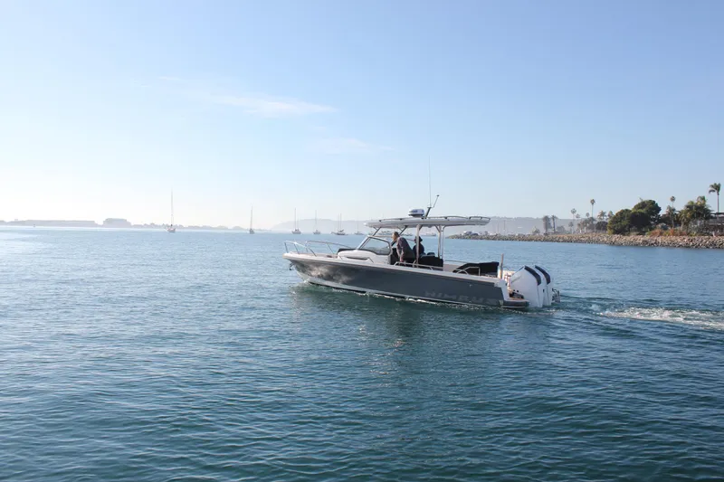 Slide: The Image of 2024 Nimbus T9 boat cruising on calm waters under a clear blue sky. - 3