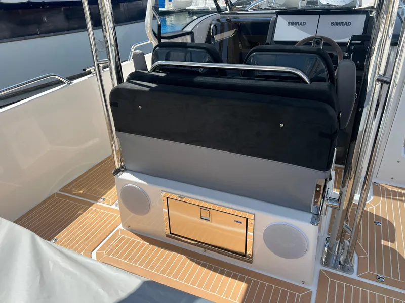 Slide: The Image of 2024 Nimbus T9 boat interior with seating and Simrad navigation system. - 7