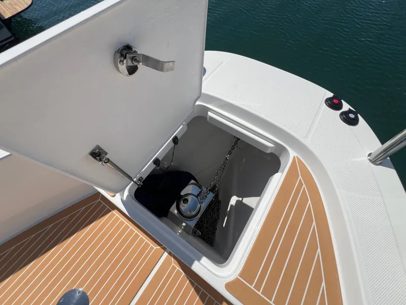 Slide: The Image of Open anchor compartment on 2024 Nimbus T9 boat with teak deck. - 9
