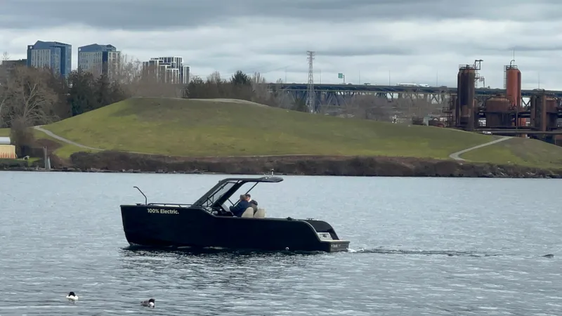 The Image of 2024 X Shore 1 electric boat cruising on Lake Union  with industrial backdrop. - 0