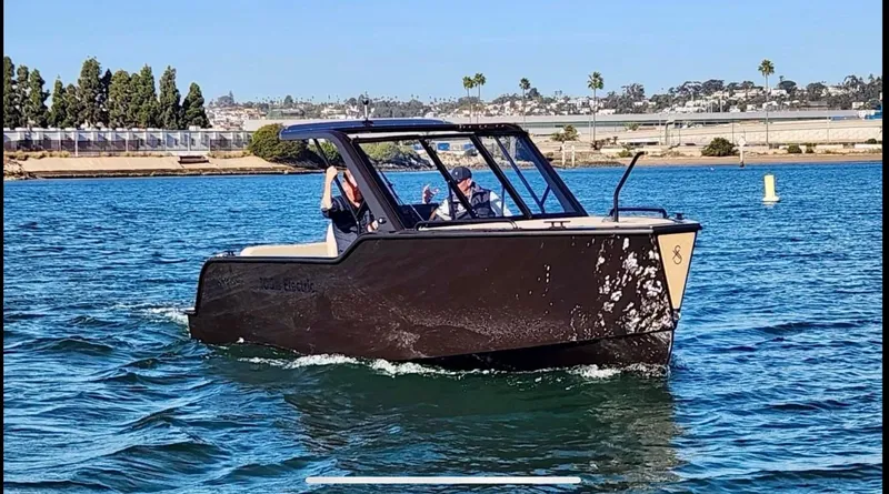 Slide: The Image of 2024 X Shore 1 electric boat cruising on a sunny day in calm waters. - 1