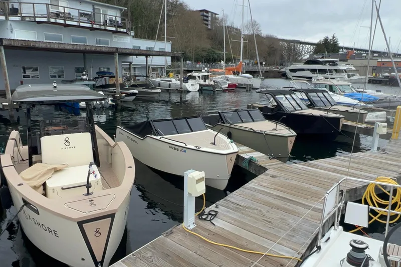 Slide: The Image of X Shore lineup docked at Signature Yachts, featuring the Eelex 8000, X Shore 1 Top Version, and the X Shore 1 Open Version electric models. - 5