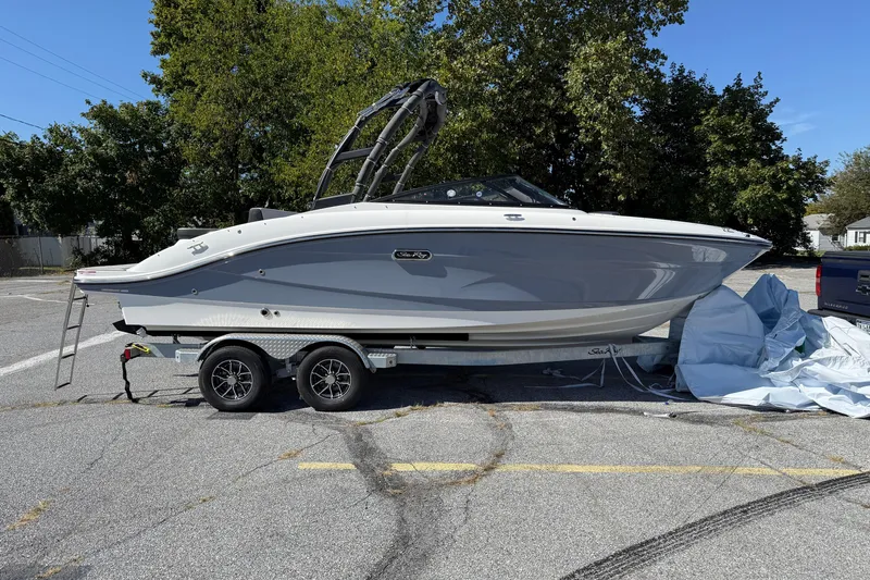The Image of 2026 Sea Ray SPX 210 boat on trailer in parking lot, sunny day. - 0