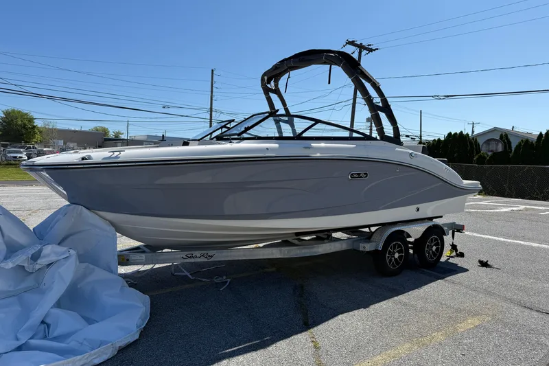 Slide: The Image of 2026 Sea Ray SPX 210 boat on trailer in sunny outdoor setting. - 2