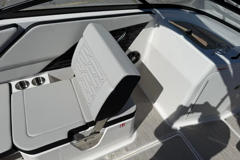 Slide: The Image of 2026 Sea Ray SPX 210 boat interior with cushioned seating and cup holders. - 8