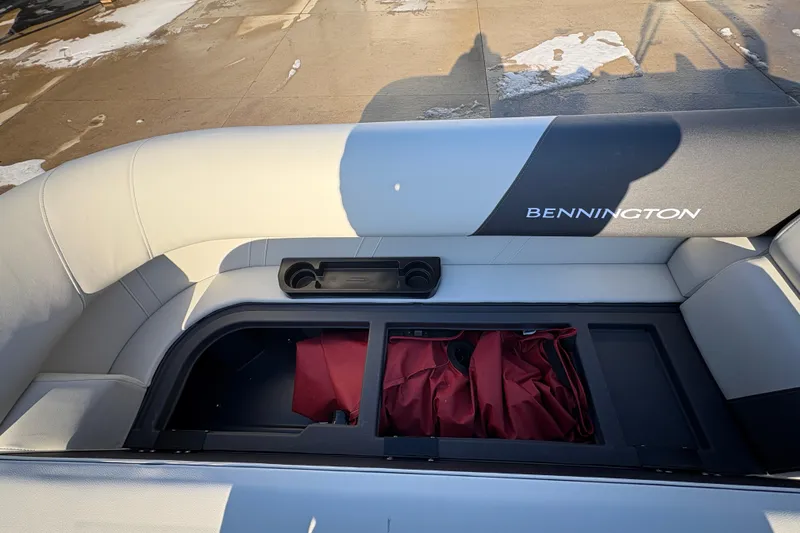 Slide: The Image of 2026 Bennington 20 SL boat interior with storage compartment and seating. - 11