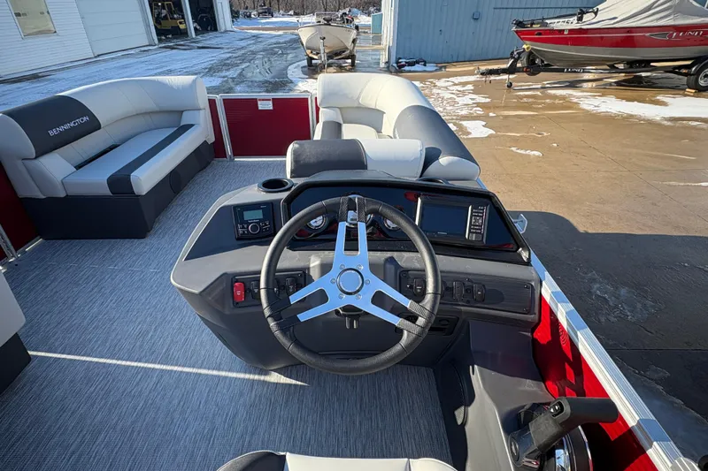 Slide: The Image of 2026 Bennington 20 SL boat interior with steering wheel and seating. - 15