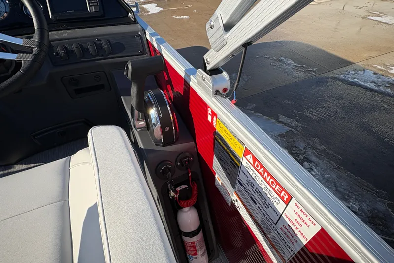 Slide: The Image of Interior of 2026 Bennington 20 SL boat with control panel and safety labels. - 16