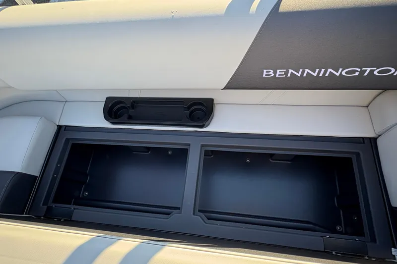 Slide: The Image of 2026 Bennington 20 SL boat seat storage with cup holders and logo. - 17