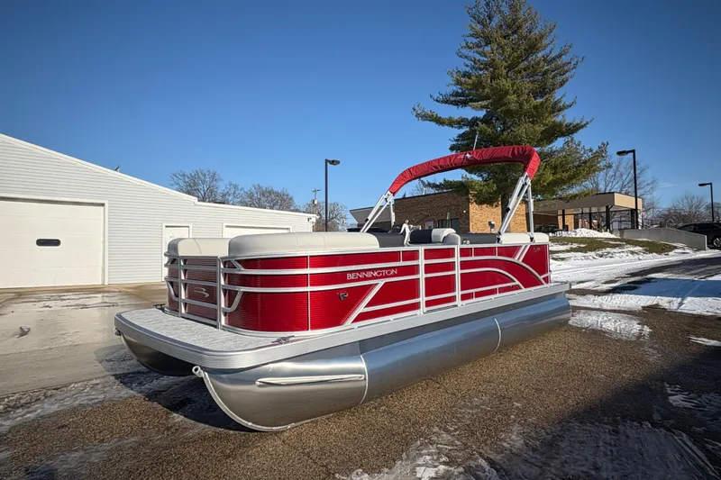 Slide: The Image of 2026 Bennington 20 SL pontoon boat with red exterior, parked outdoors on a sunny day. - 5