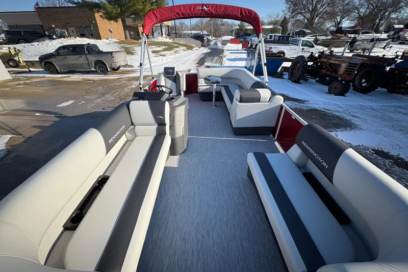 Slide: The Image of 2026 Bennington 20 SL pontoon boat with spacious seating and red canopy in snowy setting. - 7
