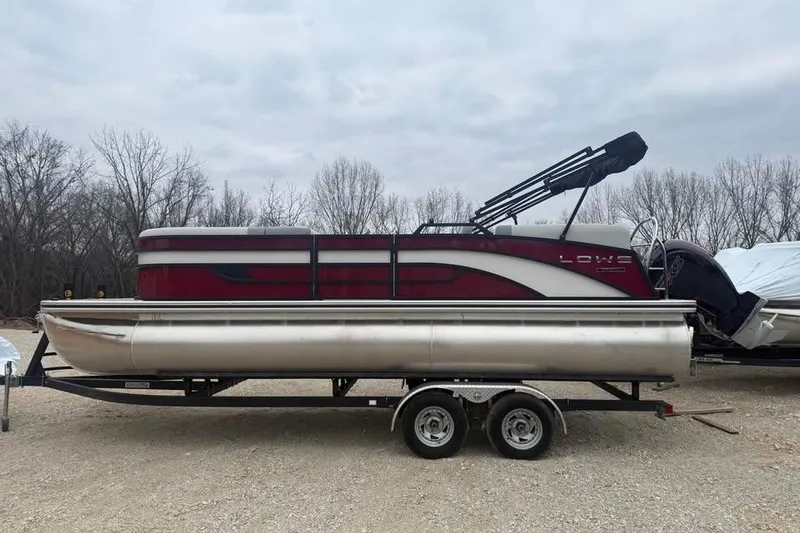 The Image of 2026 Lowe SS 230 WV pontoon boat on trailer, parked outdoors. - 0