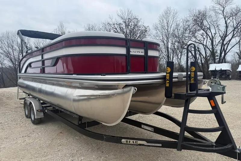 Slide: The Image of 2026 Lowe SS 230 WV pontoon boat on trailer, parked outdoors. - 3