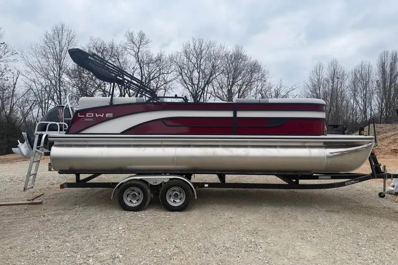 Slide: The Image of 2026 Lowe SS 230 WV pontoon boat on trailer, parked outdoors. - 4