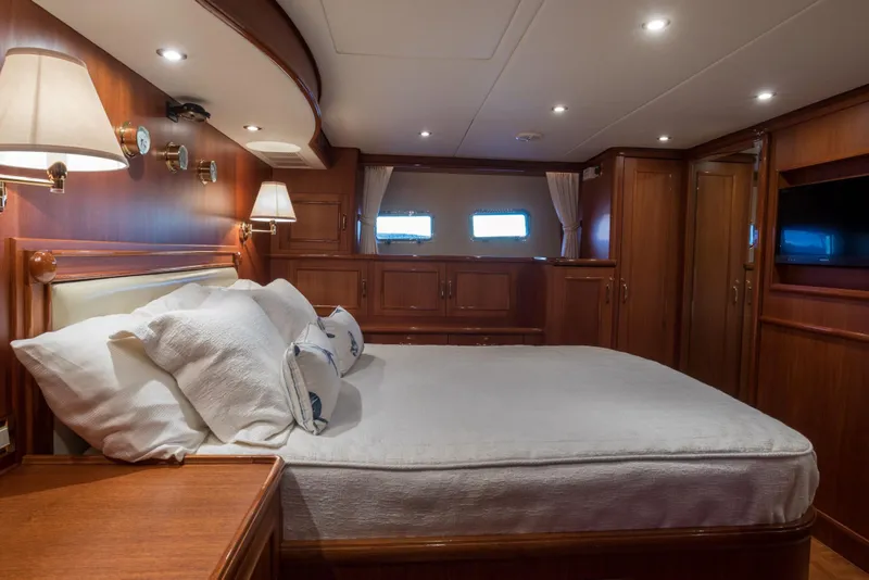 Slide: The Image of Luxurious cabin interior of 2006 Grand Banks 59 Aleutian RP yacht, featuring elegant wood finishes. - 12