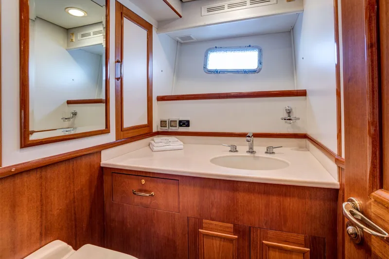 Slide: The Image of Luxurious bathroom interior of 2006 Grand Banks 59 Aleutian RP yacht, featuring wood cabinetry. - 18