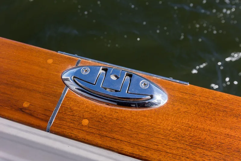 Slide: The Image of Polished metal cleat on 2006 Grand Banks 59 Aleutian RP yacht's wooden deck. - 27
